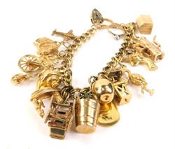 Lot 44 A 9ct gold and yellow metal charm bracelet