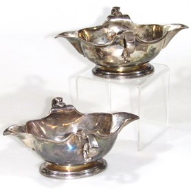 1021 A Harlequin pair of George II silver sauce boats