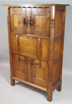 1240 An early 20thC Cotswold Gimson style Arts and Crafts oak and walnut side cabinet, probably by the workshop of Romney Green